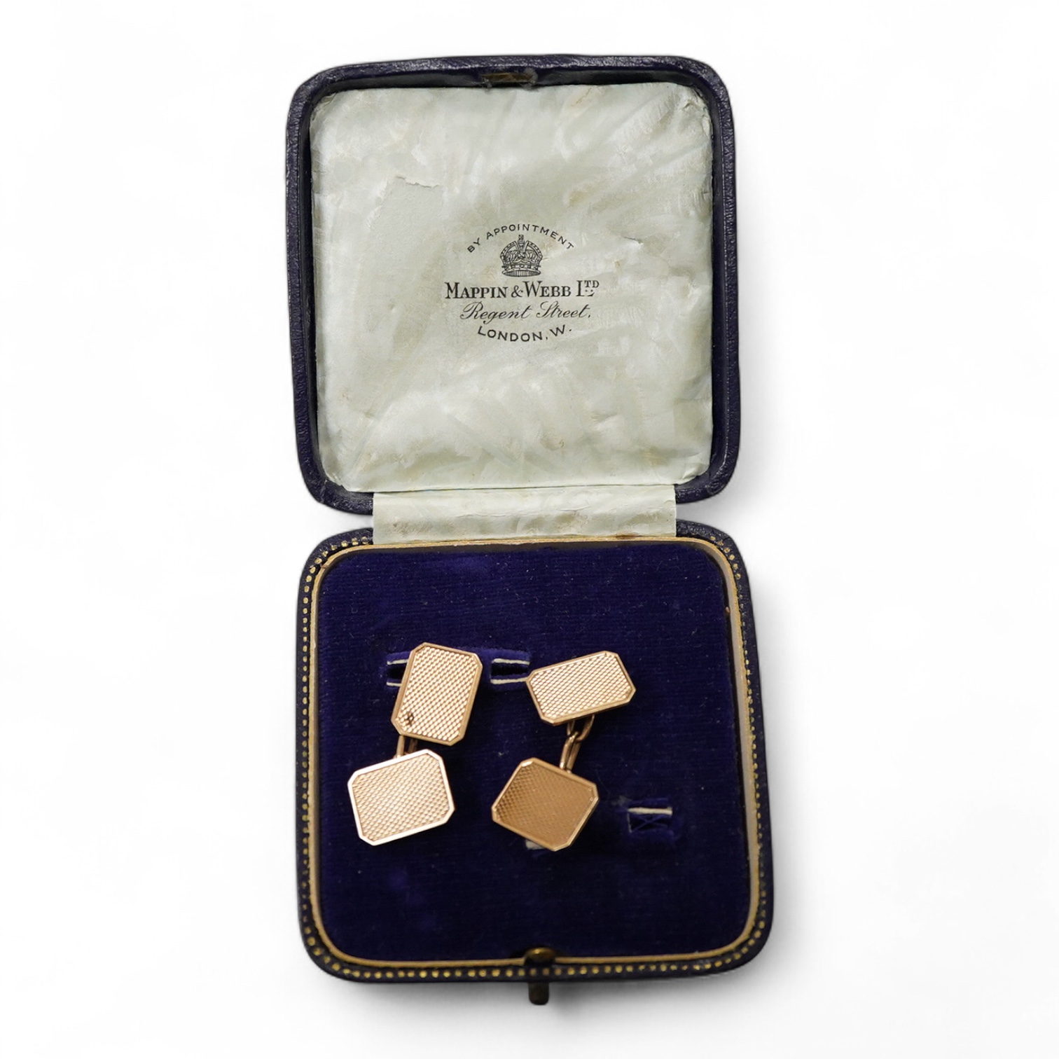 A pair of 1940's engine turned 9ct gold rectangular cufflinks by W. Wilkinson Ltd, 18mm, 6.5 grams, housed in a Mappin & Webb box.